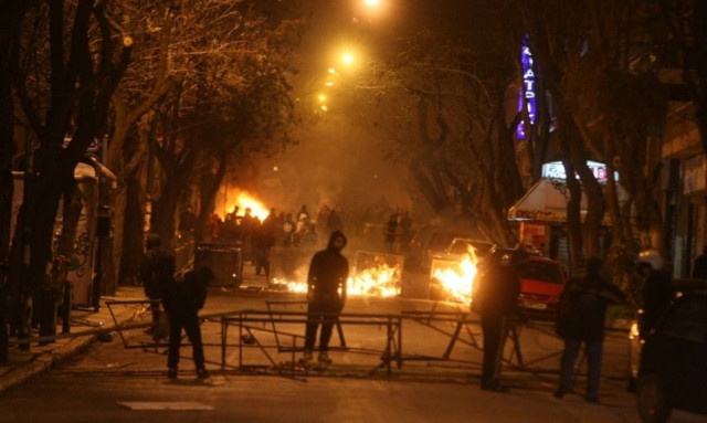 Rioters burn cars and garbage containers in Exarcheia after protest march