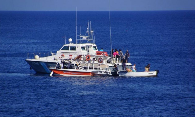 Wooden sailing boat with migrants and refugees located off the coasts of Samos
