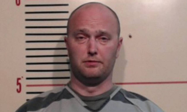 Texas officer surrenders to face murder charge in shooting of teen