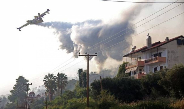 Large wildfire burning pine forest in Halkidiki