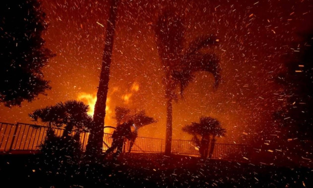 Evacuations as fire rages along California freeway