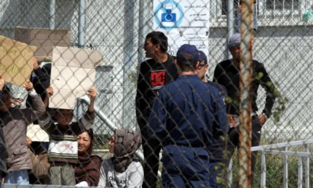 Inquiry launched into video of policemen mistreating elderly woman in Moria