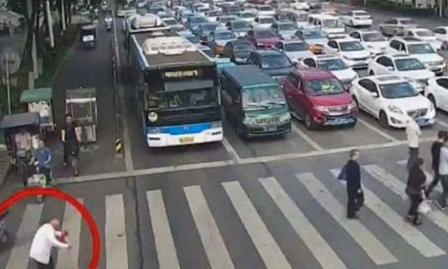 Τροχονόμος κουβαλάει στην πλάτη του παππούλη που δεν μπορεί να περάσει το δρόμο! (vid)