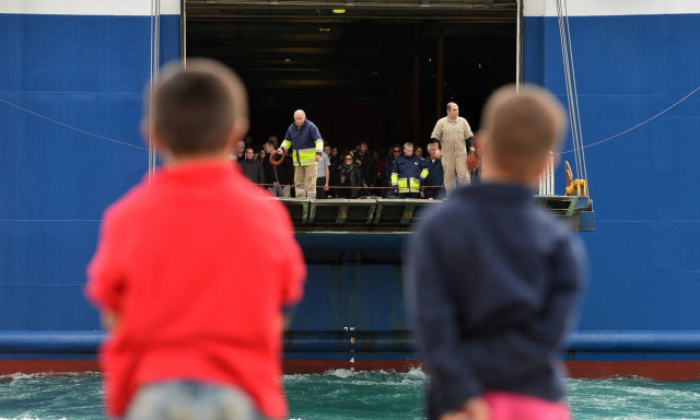 Two ships carrying asylum seekers from the islands arrive at the port of Piraeus