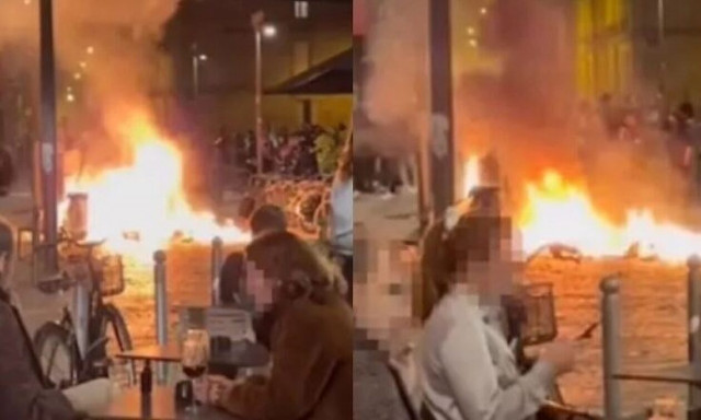 Αμφιλεγόμενο βίντεο δείχνει ζευγάρι να πίνει αμέριμνα το ποτό του τη στιγμή που το Παρίσι φλέγεται