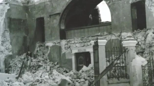 a building with rubble and a door