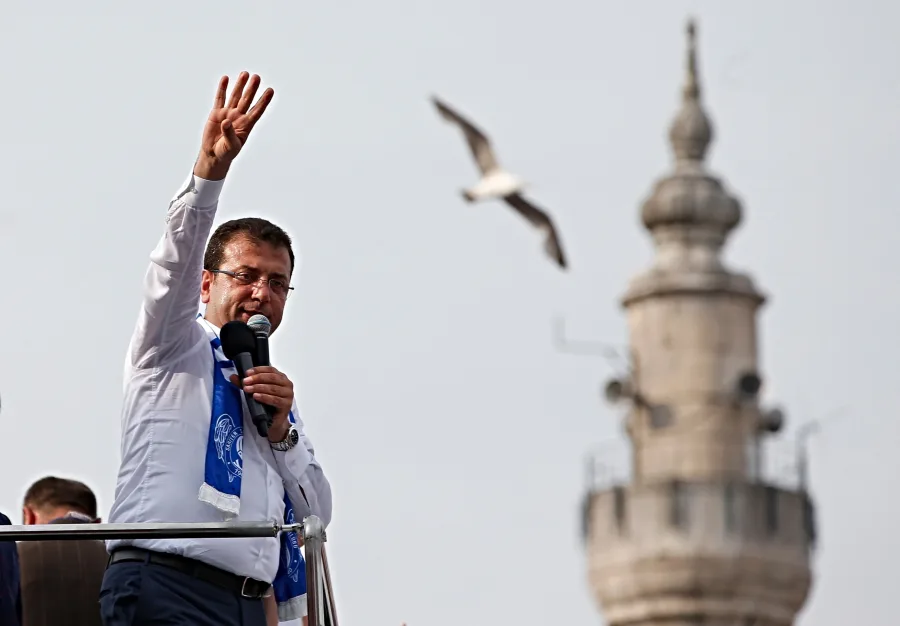 a man holding a microphone and waving