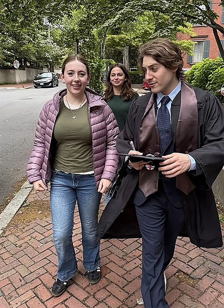 James and his twin sisters Tabitha and Marion at his graduation Tuesday.