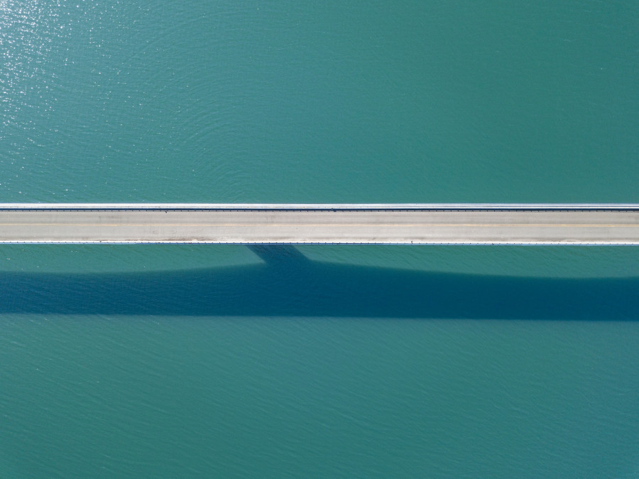 Aerial view of cars on bridge over river