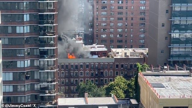 A massive fire broke out on the rooftop of 305 E 95th Street on Manhattan's Upper East Side