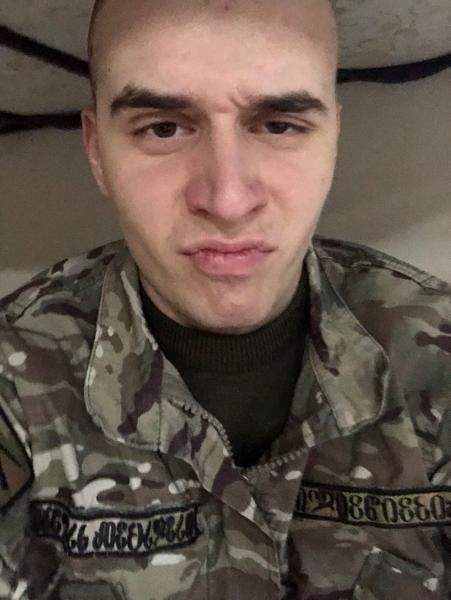 Michail “Commander Butcher” Chkhikvishvili, 21, wearing a camouflage military uniform.