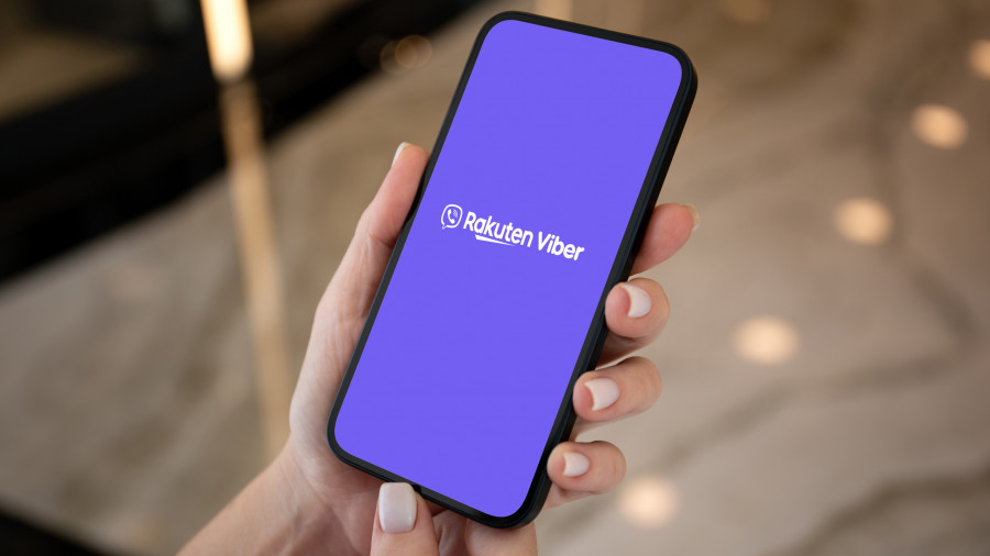 Female hands hold phone with isolated screen on background street