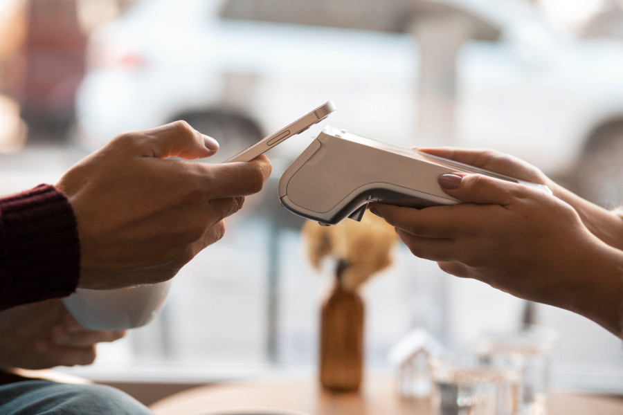 person-using-nfc-technology-pay-bill-restaurant.jpg