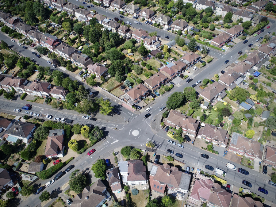 Aerial shot of a cityscape, a central intersection with traffic